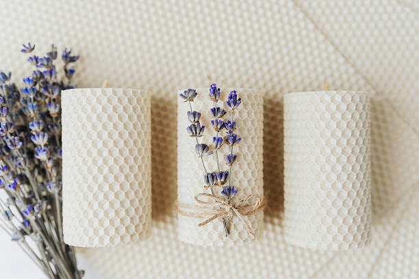 Hand-poured beeswax candles with dried lavender sprigs